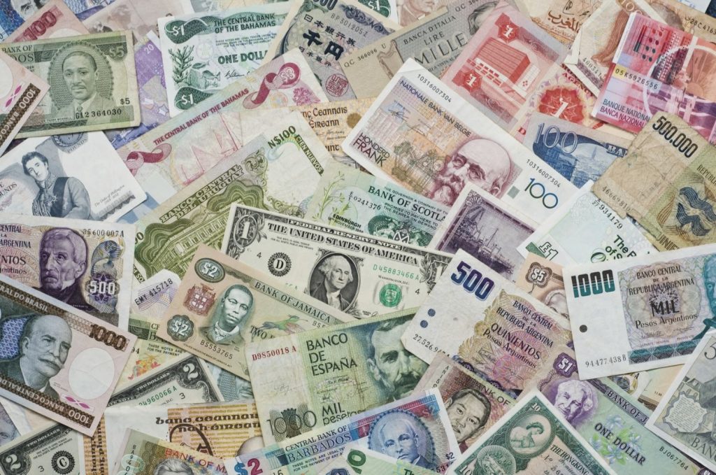 A collage of various currencies from around the world.