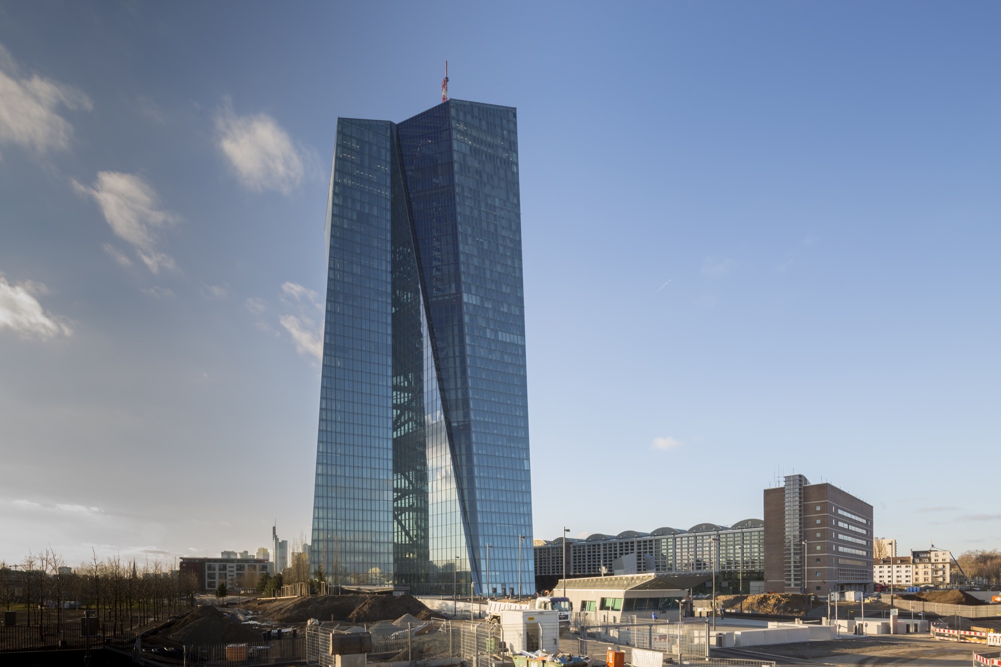 A photo of the European Central Bank headquarters building, a blue glass skyscraper located in Frankfurt, Germany.